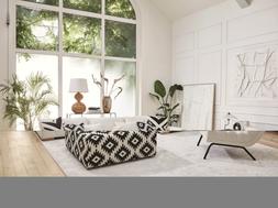 DFS Calix right hand facing large chaise end sofa in in ivory boucle, Calix pattern large square footstool, and Calix ripple accent chair in ivory boucle