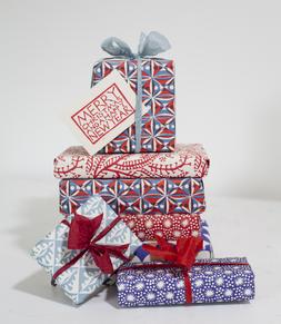 Pile of presents wrapped in Cambridge Imprint paper