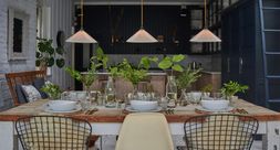 White glass Hay pendant lights over a kitchen table