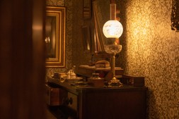 Restored antique oil lamp in bedroom by Fritz Fryer