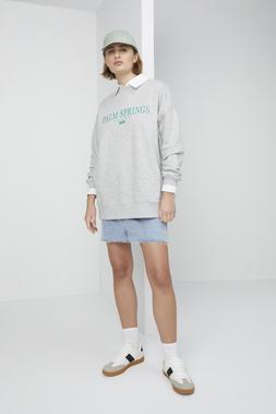 Sage Green Cap &pound;8, Oversized Grey Palm Springs Sweatshirt &pound;16, Blue Denim Mini Skirt &pound;16, White Retro Trainers &pound;18
