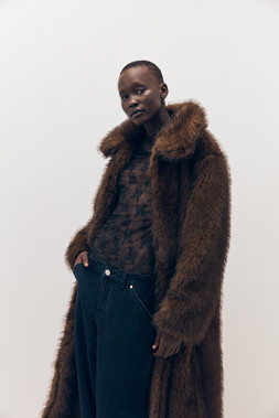 Tu-AW26-Model-20 - Brown Longline Faux Fur Coat £55, Chocolate Lace Second-Skin Long Sleeve Top £10, Dark Denim Balloon Jean £22.50