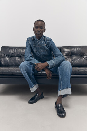 Tu-AW26-Model-19 - Mid Denim Military Jacket £30 Mid Denim Turn-Up Barrel Jeans £22.50 Black PU Penny Loafer £20